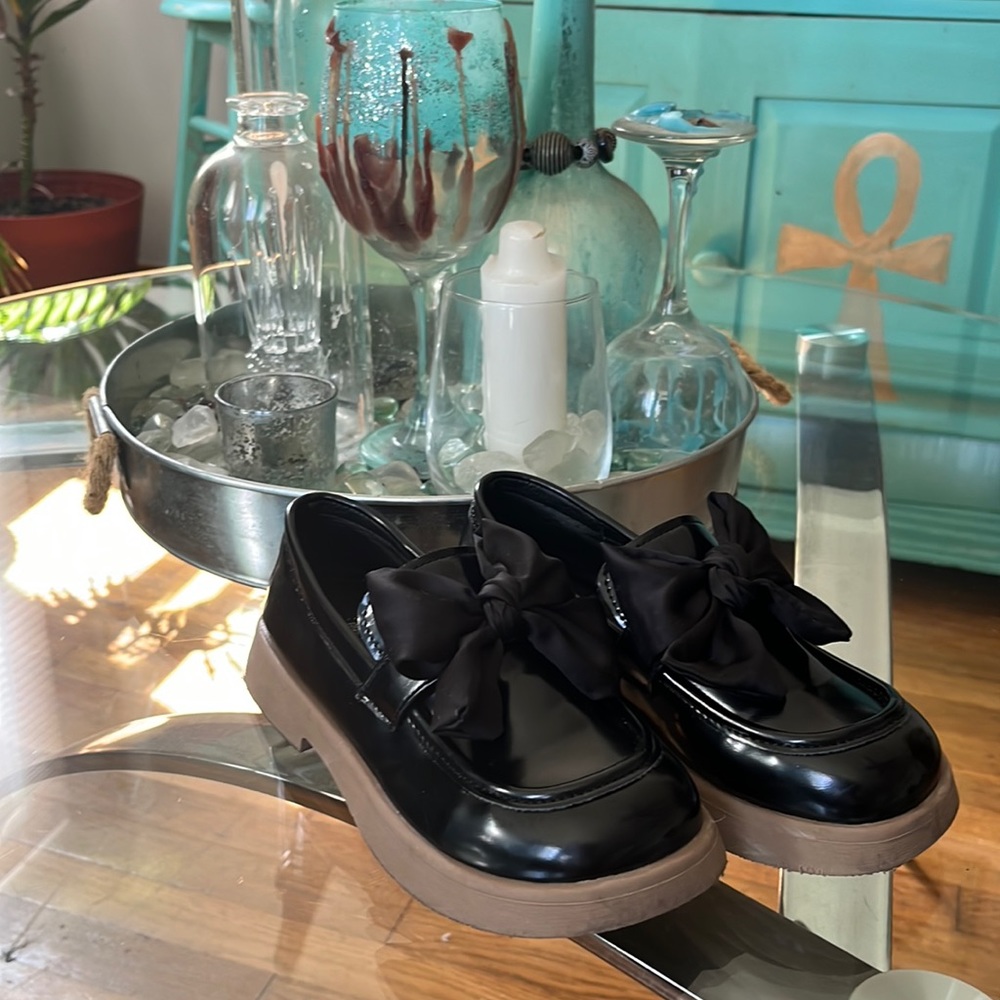 Black loafers with bows